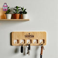 Wall-mounted wooden key hanger with five cut-out slots