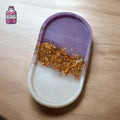 Oval purple and white resin tray with a band of gold flakes