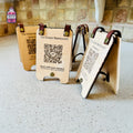 Engraved wooden QR menu stands displayed on a restaurant counter