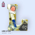 Large resin letter with embedded baby photos and keepsakes