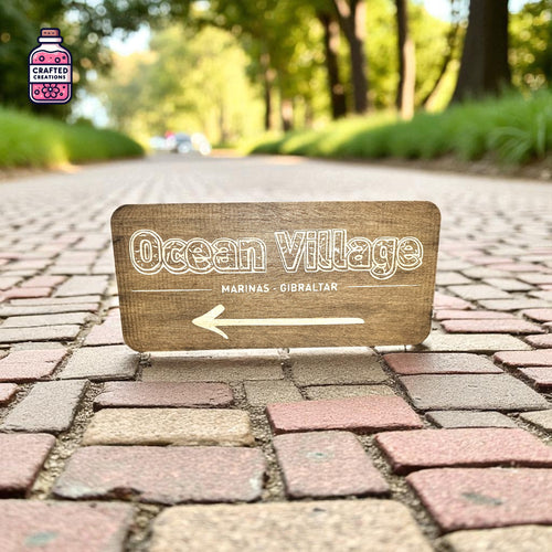 Engraved wooden Ocean Village direction sign with arrow