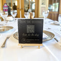 Small slate table sign with QR code on a wooden easel