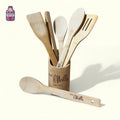 Wooden kitchen utensils displayed in an engraved holder