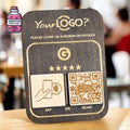Dark wooden NFC and QR review plaque displayed on a table