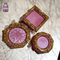 Three purple resin ashtrays with gold flakes in different shapes