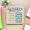 Wooden children's reward chart with a name and movable coloured markers