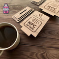 Wooden NFC and QR review plaques displayed beside a cup of coffee