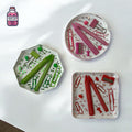 Three translucent resin stationery coasters with embedded miniature supplies